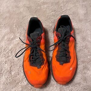 On Running Bright Orange and Black Athletic Shoes